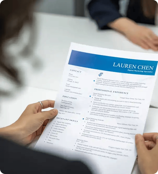 A close-up of a person holding a professional resume for a Digital Marketing Specialist, symbolizing the vocational training and career development support provided during Jango's Pathways to Potential program.