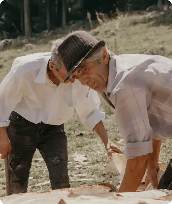 Two men in hats work together outdoors on a rural project, symbolizing Jango's commitment to hands-on support, community engagement, and supporting the active lifestyle of seniors and NDIS participants across our regional service areas.