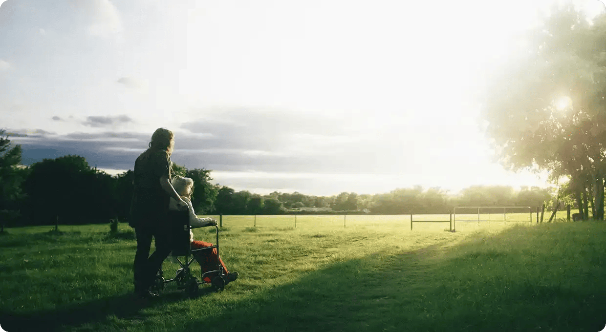 A smiling person in a wheelchair, representing the joyful and compassionate in-home care services Jango offers to support dignity and independence for older Australians.