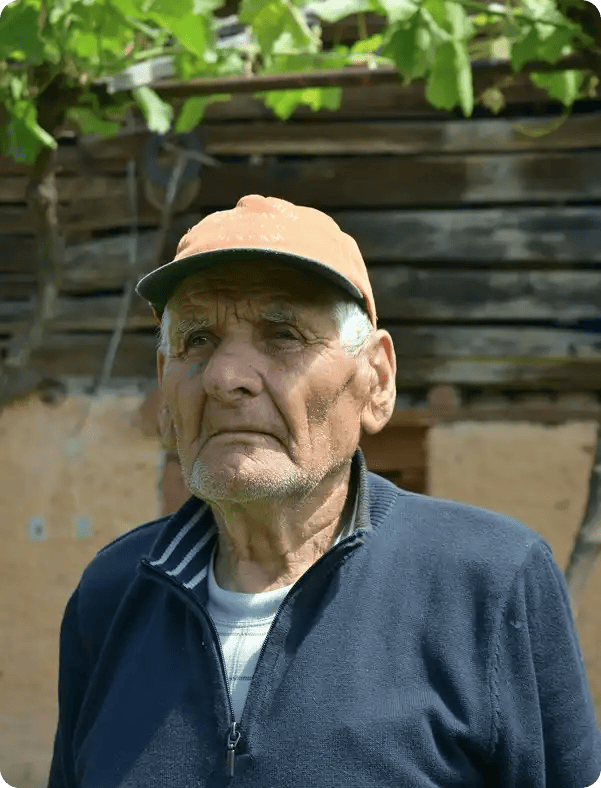 A close-up black and white photograph of an older man in a moment of reflection, symbolizing the depth of lived experience and the personalized emotional support provided through Jango’s recovery coaching.