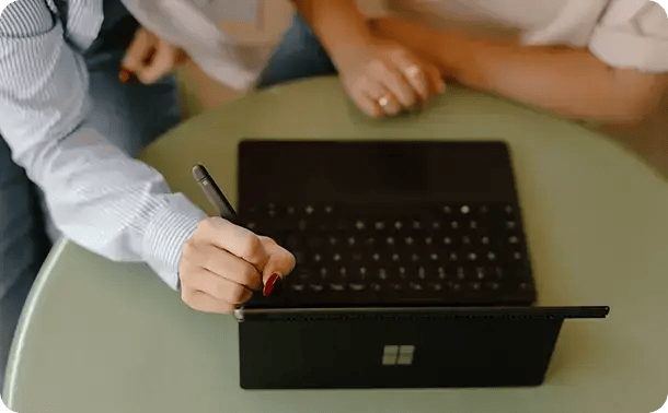 A close-up view of a person using a digital stylus on a tablet keyboard, representing Jango’s modern, tech-enabled approach to NDIS plan management and coordination across all our service regions.
