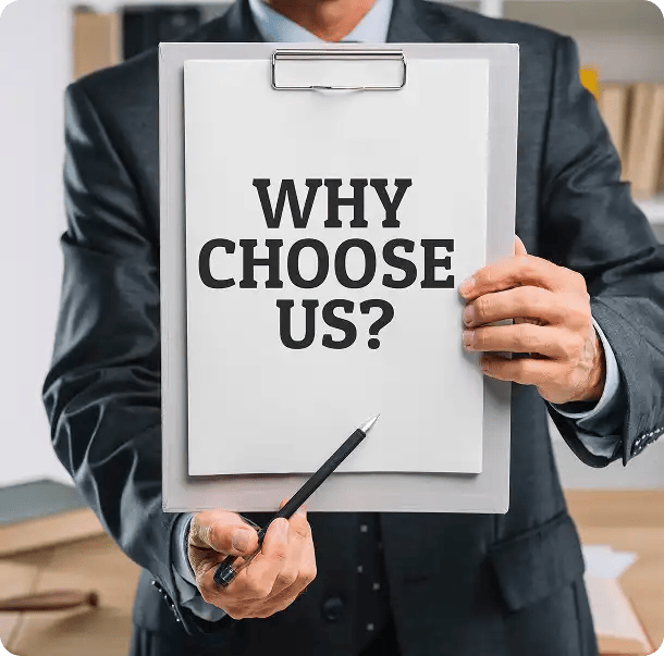 A professional in a suit holding a clipboard with the text "WHY CHOOSE US?" and pointing with a pen, highlighting the specific benefits and professional standards that set the Jango team apart as a leading NDIS provider.